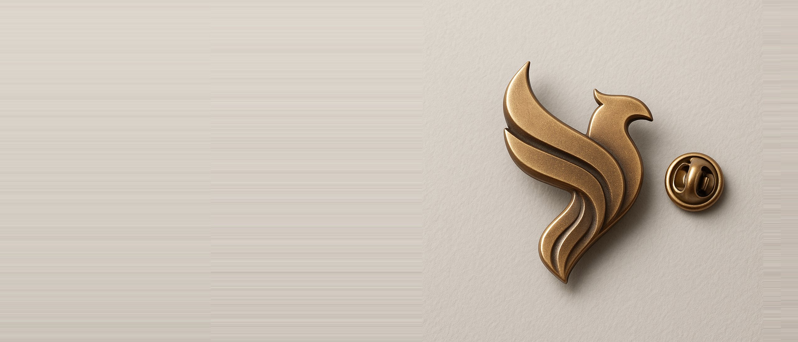 The Phoenix Foundation emblem struck in brass as a lapel badge